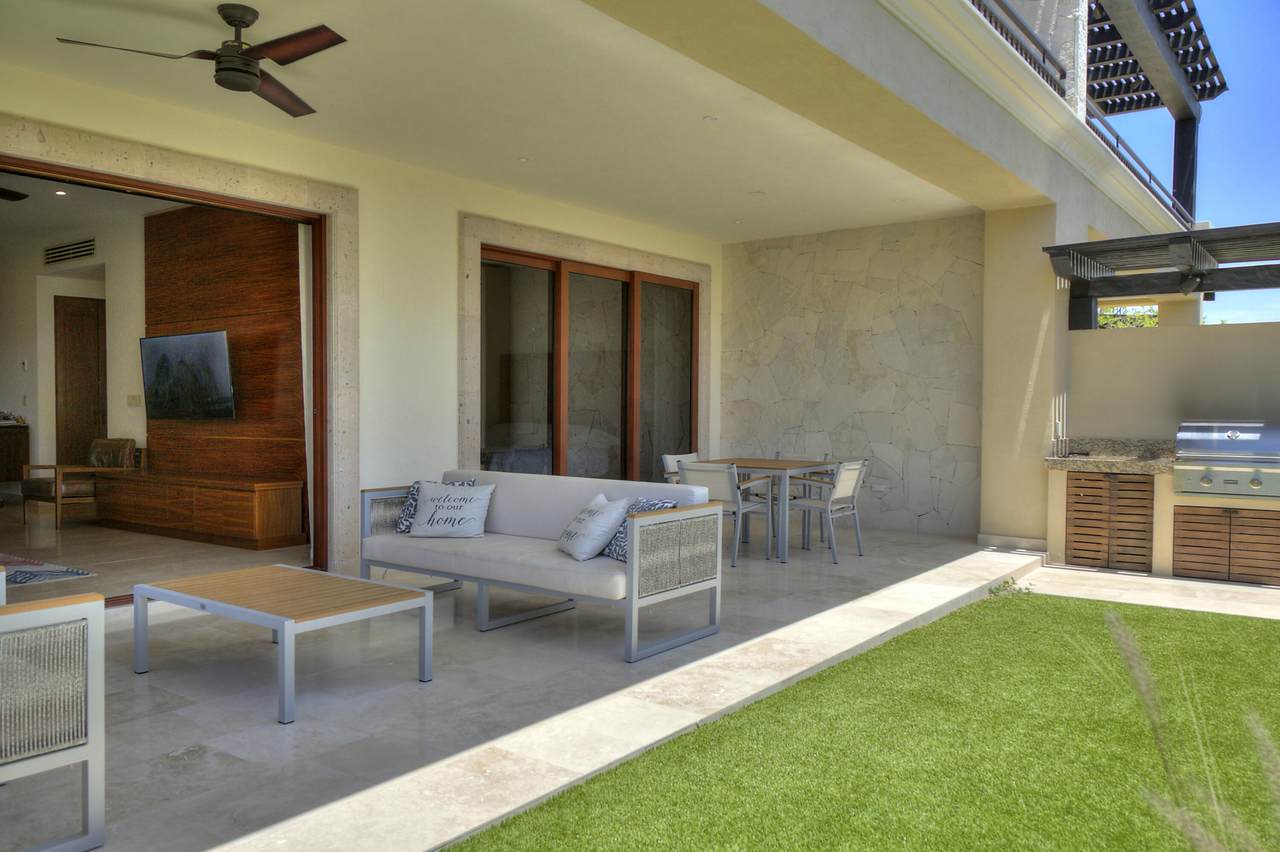 A Patio With A Couch And Table And Chairs