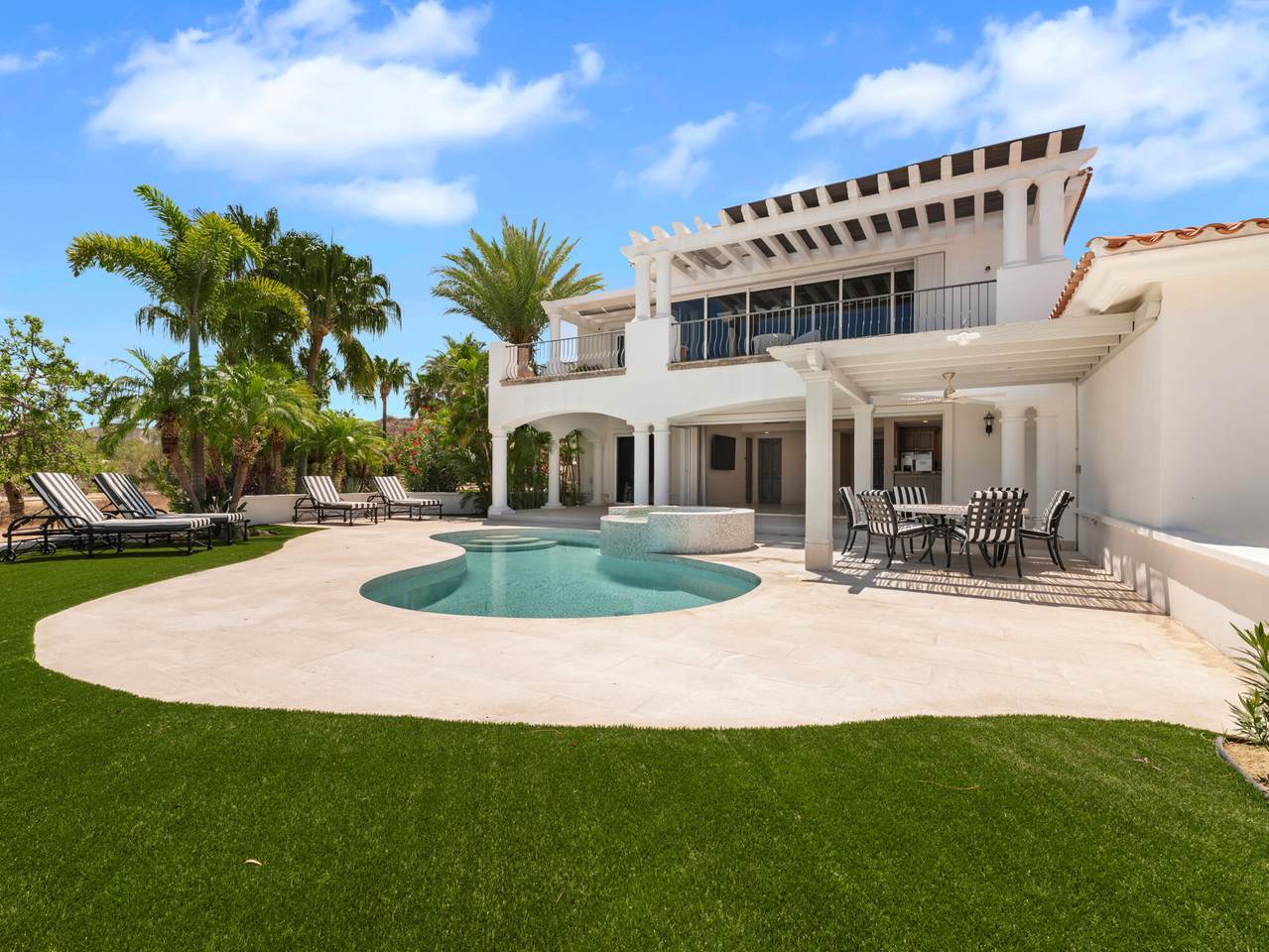 A House With A Pool And Palm Trees
