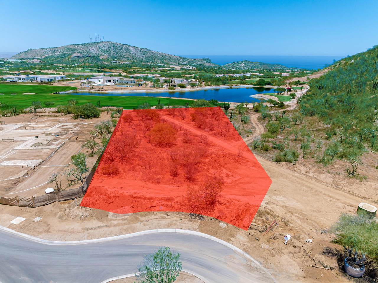 A Red Square On A Dirt Road Surrounded By Trees And Water