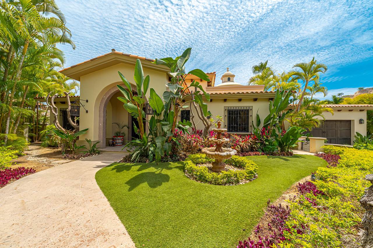 A House With A Fountain In Front Of It